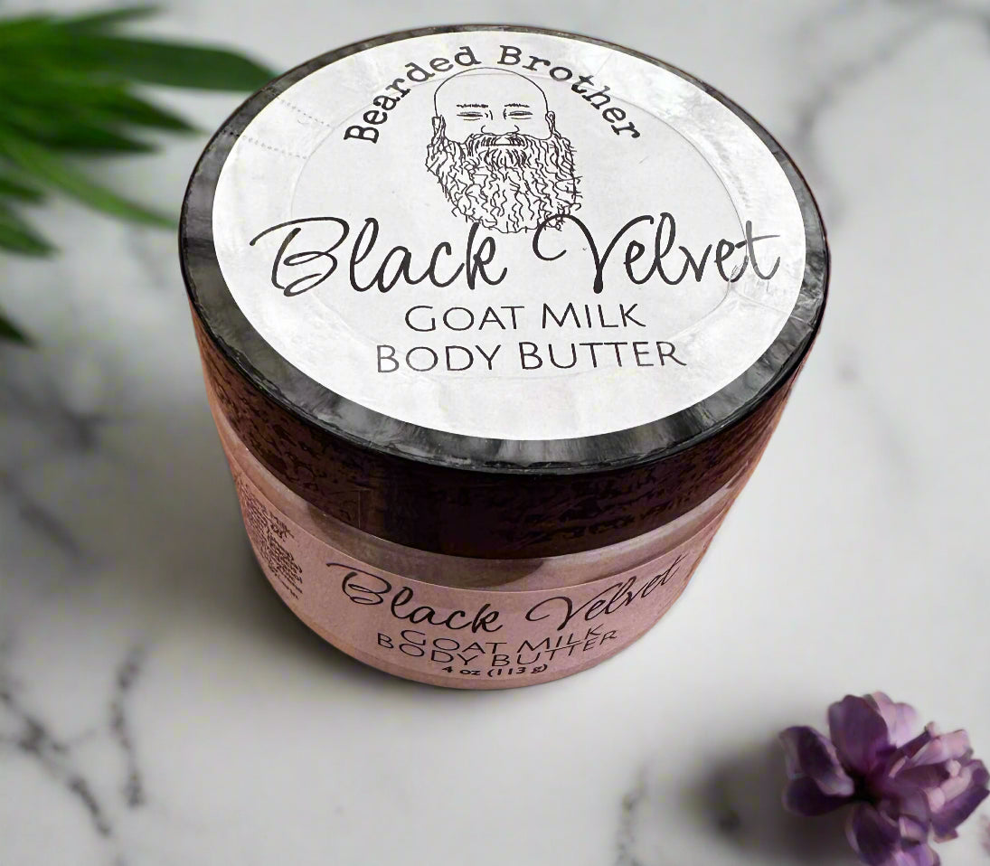 Jar of Black Velvet Goat Milk Body Butter on a wooden surface